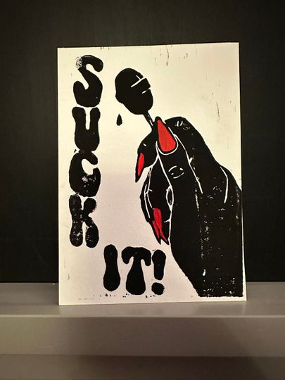 Discover Suck it! Linocut print in black and red