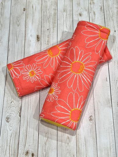Discover Coral daisy car seat strap covers