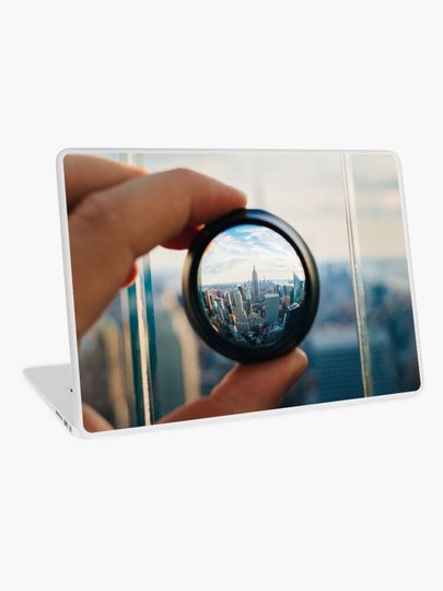 Discover Man holding a lens over Manhattan | Laptop Skin