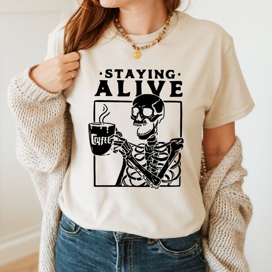 Discover Staying Alive T-shirt for Women, Trendy Coffee Shirt, Funny Skeleton Tee