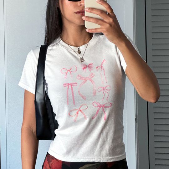 Discover Coquette Bow Baby Tee, Vintage Graphic Coquette Shirt Aesthetic Cinnamon Girl Baby Tee