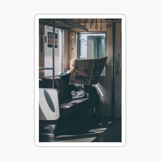 Discover Japanese Man Reading a Newspaper On a Train