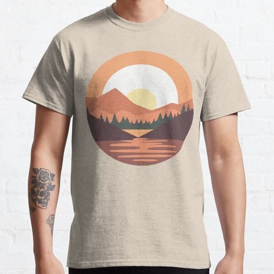 Sunrise behind mountains at a lake