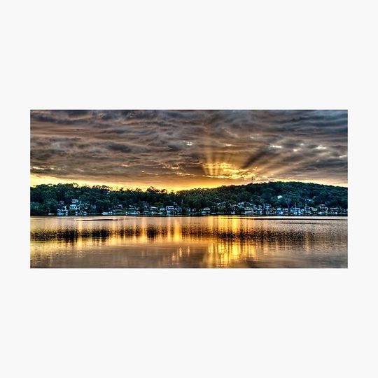 Discover Golden Crepuscular Sunrise over Water.