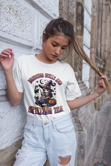 Discover Breaking Spells And Spilling Tea Halloween Funny T-shirt, Witch T-shirt, Halloween 2024 T-shirt