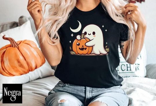 Discover Halloween T-shirt of a little ghost hugging a pumpkin cute