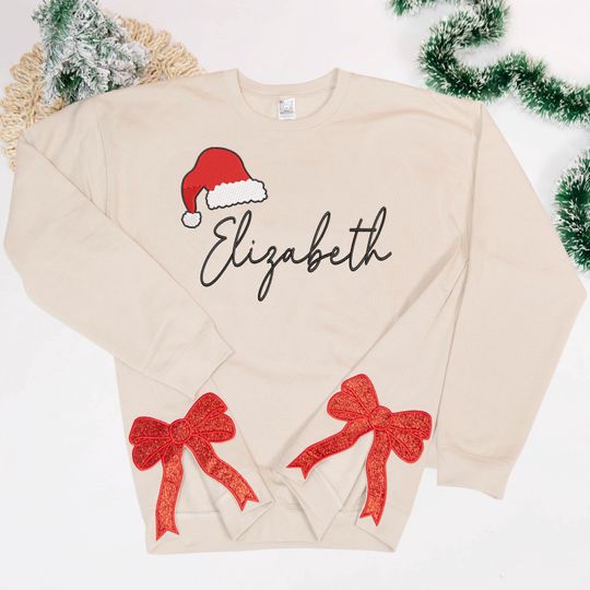 Discover Custom Name Santa Hat Side Bow Sweatshirt, Trendy Coquette Bow Sweatshirt