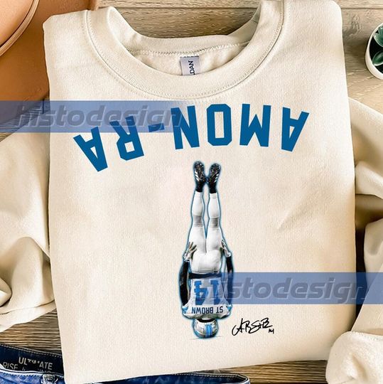 Discover Amon-Ra St Brown Head Stand Unisex Softstyle T-Shirt