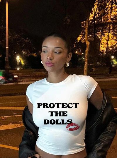 Discover Protect the Dolls Baby Tee  Girly Streetwear Brat Aesthetic Graphic