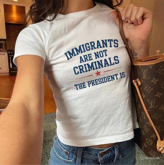 Discover Immigrants Are Not Criminals But The President Is-Anti Trump Baby Tee