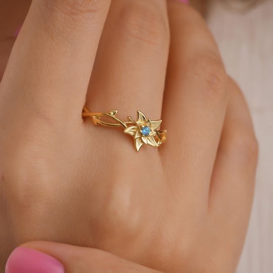 Discover December Birth Flower Ring, Poinsettia Jewelry with Blue Topaz, Nature-Inspired Birthday Gift