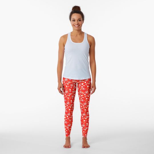 Discover White Christmas Snowflakes on a Festive Red Background Leggings
